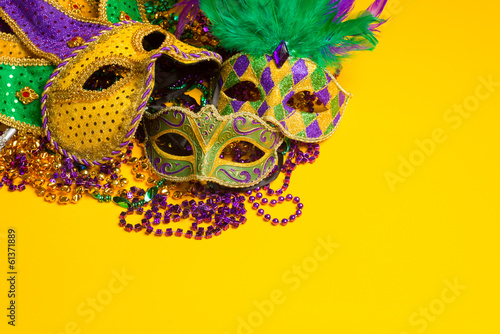 Fotografie group of Mardi Gras or venetian mask sor costumes on a yellow