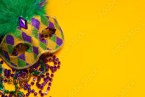 Colorful Mardi Gras or venetian mask on yellow