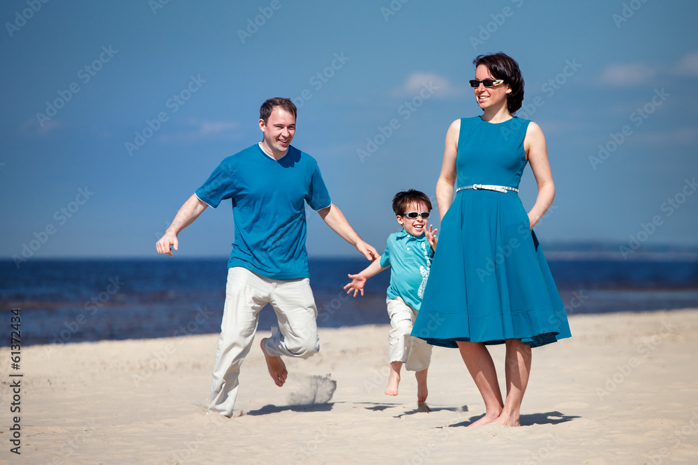 Young family of three having fun tropical beach Young family of three having fun tropical beach