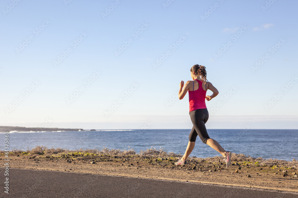 Young woman jogging along the seacoast