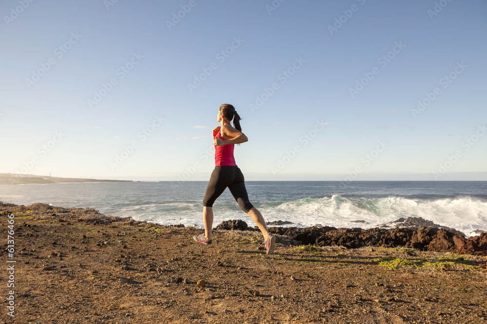 Young woman jogging along the seacoast