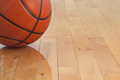Low angle view of basketball on wooden gym floor © Daniel Thornberg