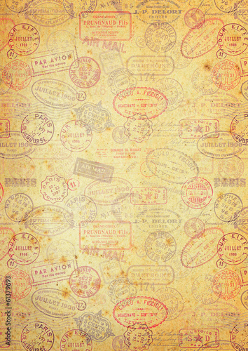 grungy paper background with vintage postage stamps