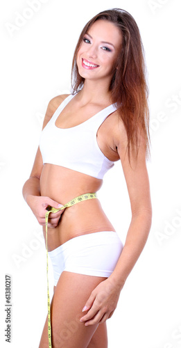 Beautiful young woman measu...