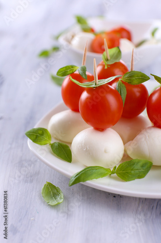 Tasty mozzarella cheese with basil and tomatoes