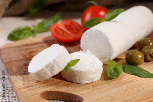 Tasty bushe cheese with tomatoes, olives and basil,