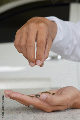 man's hand, holding 2 coin