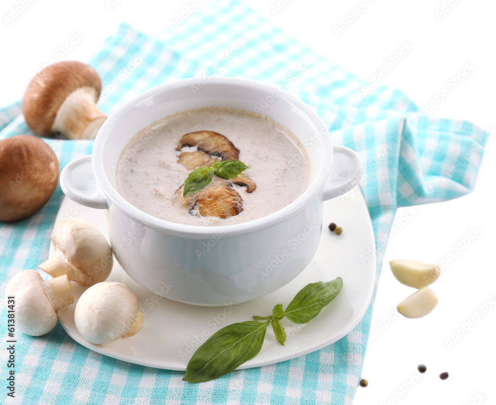 Mushroom soup in white pot, on napkin, isolated on white Mushroom soup in white pot, on napkin, isolated on white