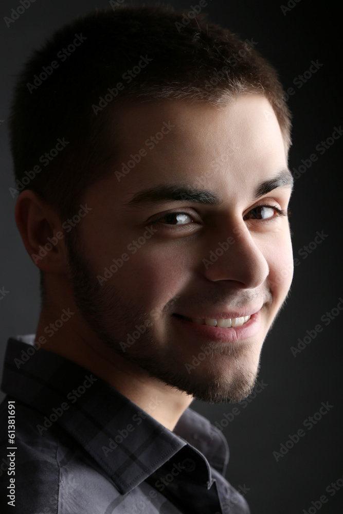 Fototapeta premium Handsome young man on dark background