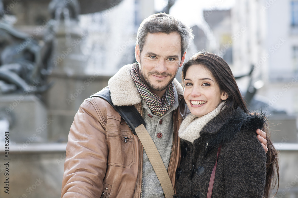 handsome couple portrait with fountain in background handsome couple portrait with fountain in background