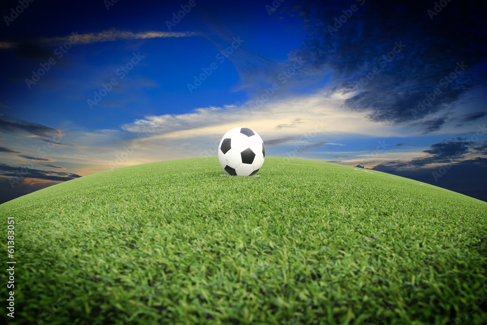 view of green striped football field with soccer ball view of green striped football field with soccer ball