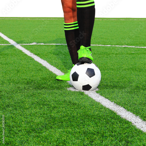 Kicking a soccer ball on field © somkanokwan