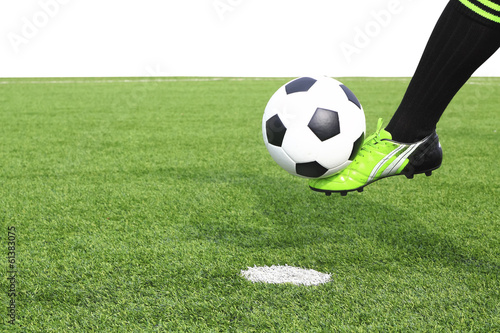 Kicking a soccer ball on field