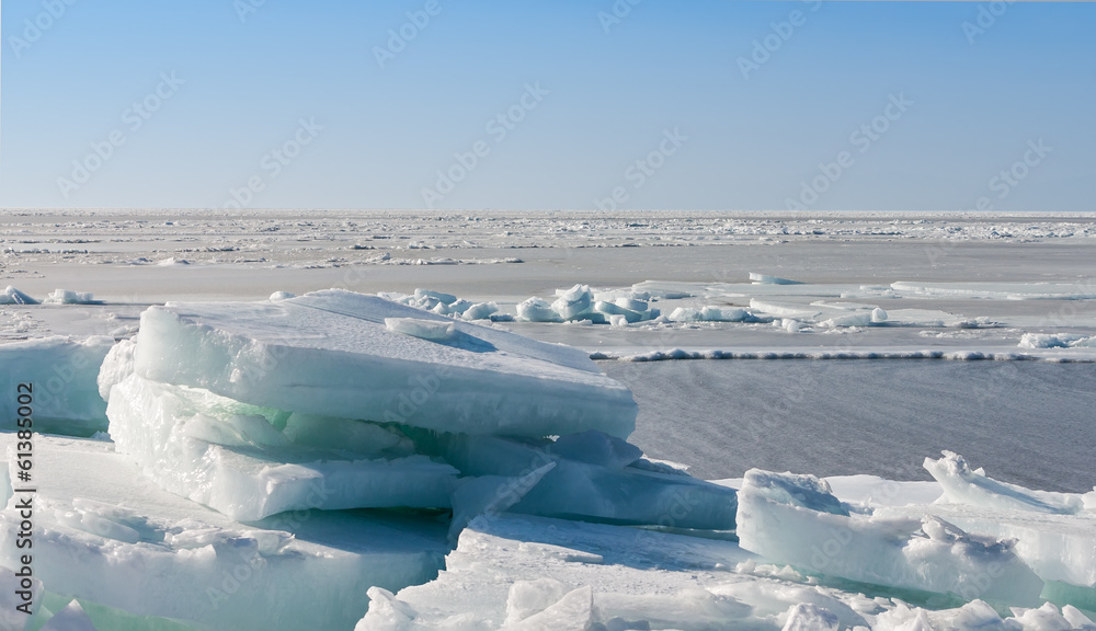 Frozen sea view on sunny day. Selective focus on ice rock. Frozen sea view on sunny day. Selective focus on ice rock.