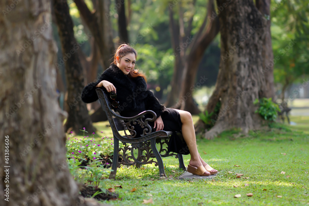 Beautiful Asian lady in black dress, posing in the park, greener Beautiful Asian lady in black dress, posing in the park, greener