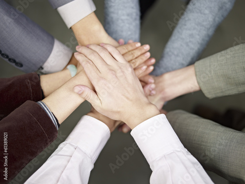 business team putting hands together to show unity