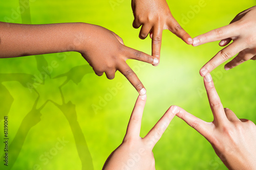 Kids joining fingers forming a star. photo