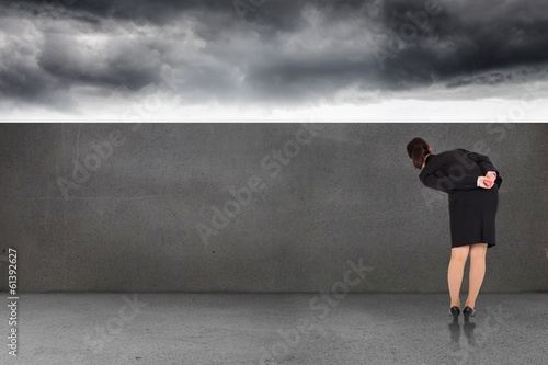 Composite image of businesswoman bending