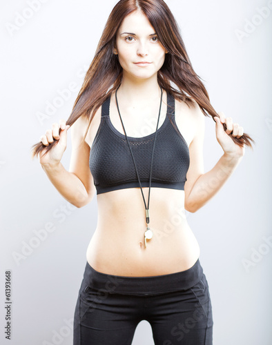 Fotografie Young athletic woman posing in sports bra