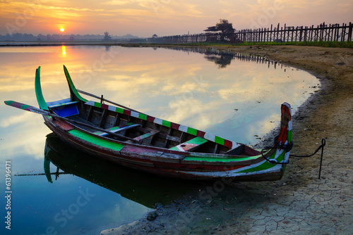 Wooden boat in Ubein Bridge at sunrise, Mandalay, Myanmar © lkunl