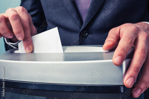 Businessman shredding documents photo