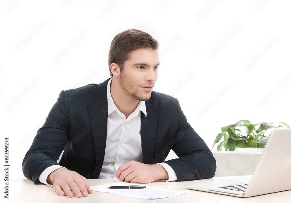 young attractive man working at his work. young attractive man working at his work.
