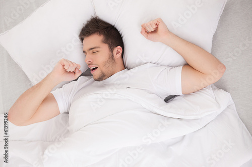 young attractive man waking in morning.