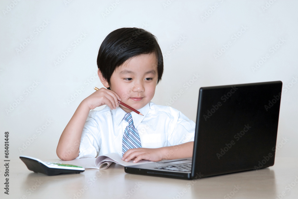 Happy Asian school boy in front of laptop computer Happy Asian school boy in front of laptop computer
