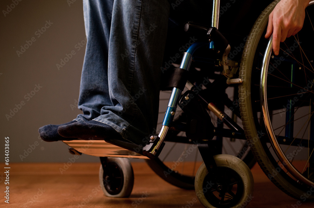 Obraz premium Close-up of male hand on wheel of wheelchair