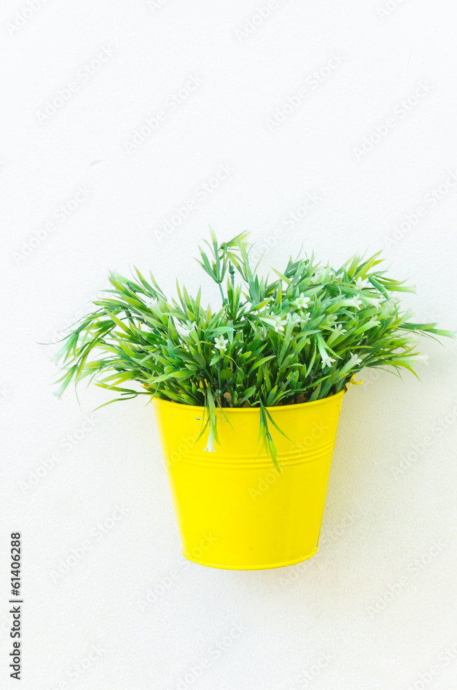 Plastic flower in vase on wall background Plastic flower in vase on wall background