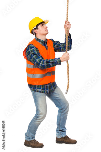 Construction worker pulling a rope.