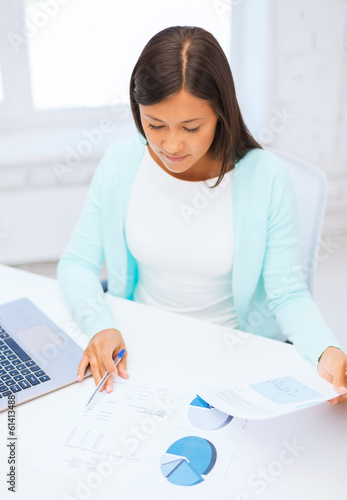 businesswoman or student with laptop and documents