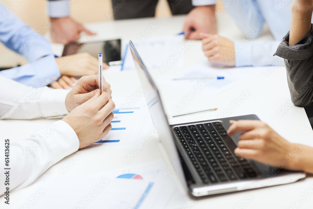 close up of files and laptop computer in office