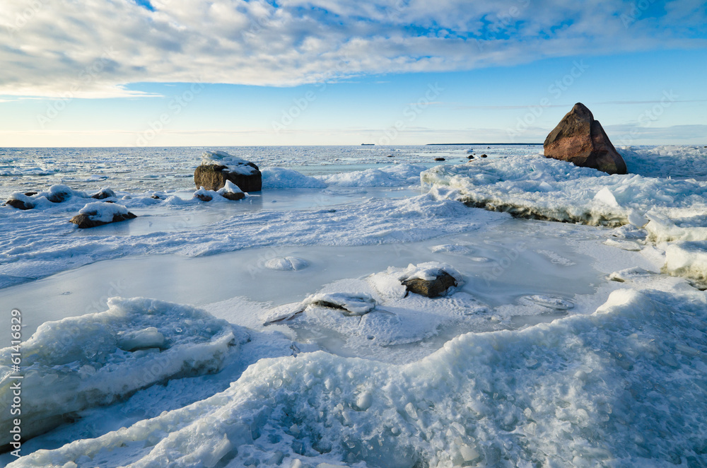 Stones in the ice on the Baltic Sea coast