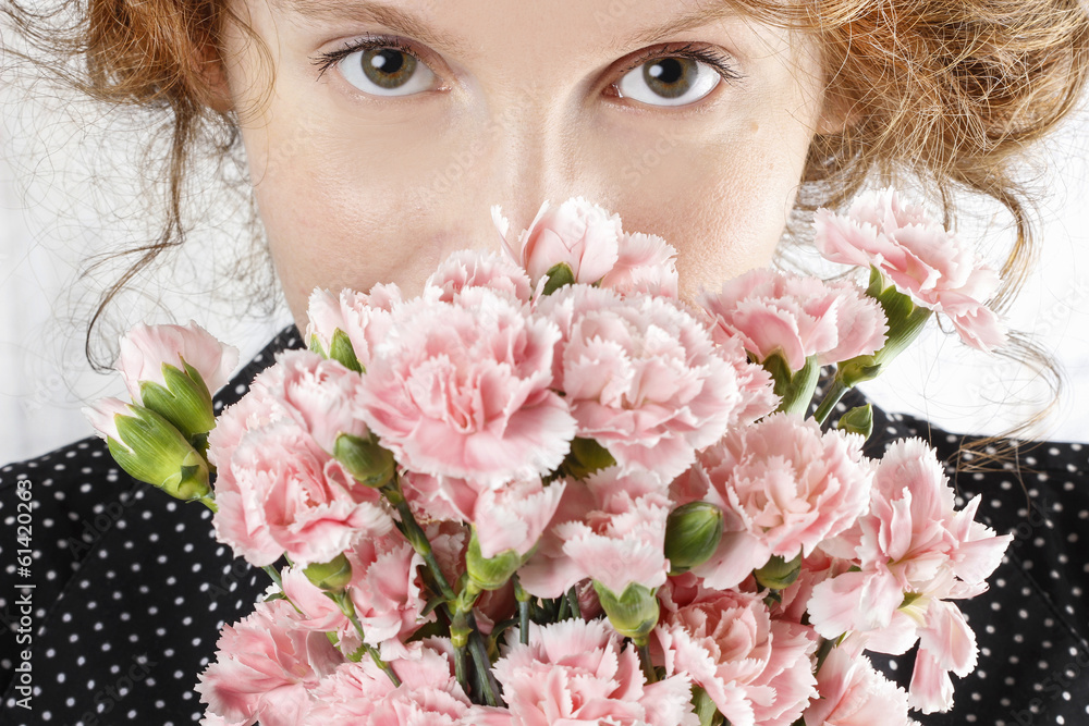 Beautiful young woman holding bouquet of pink carnation Beautiful young woman holding bouquet of pink carnation