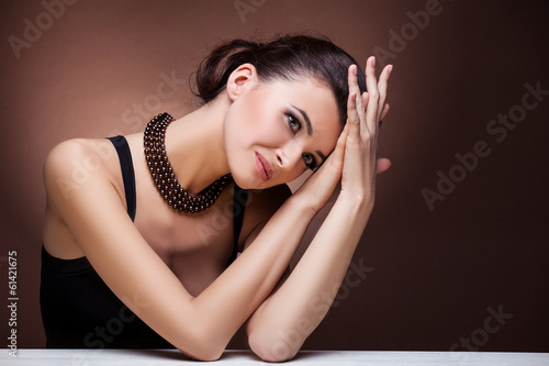 Woman posing in exclusive jewelry. Professional makeup