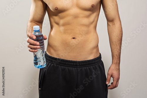 Closeup of man holding bottle of water