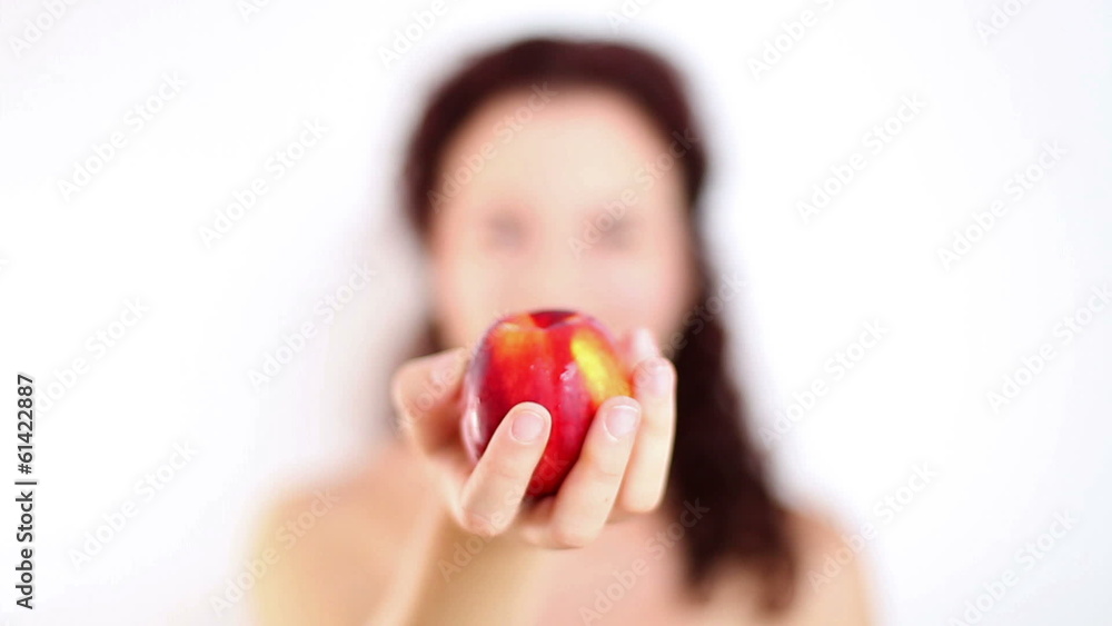 Woman with beautiful smile showing fresh peach Woman with beautiful smile showing fresh peach