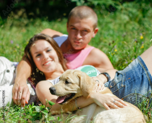 Couple With Their Puppy.