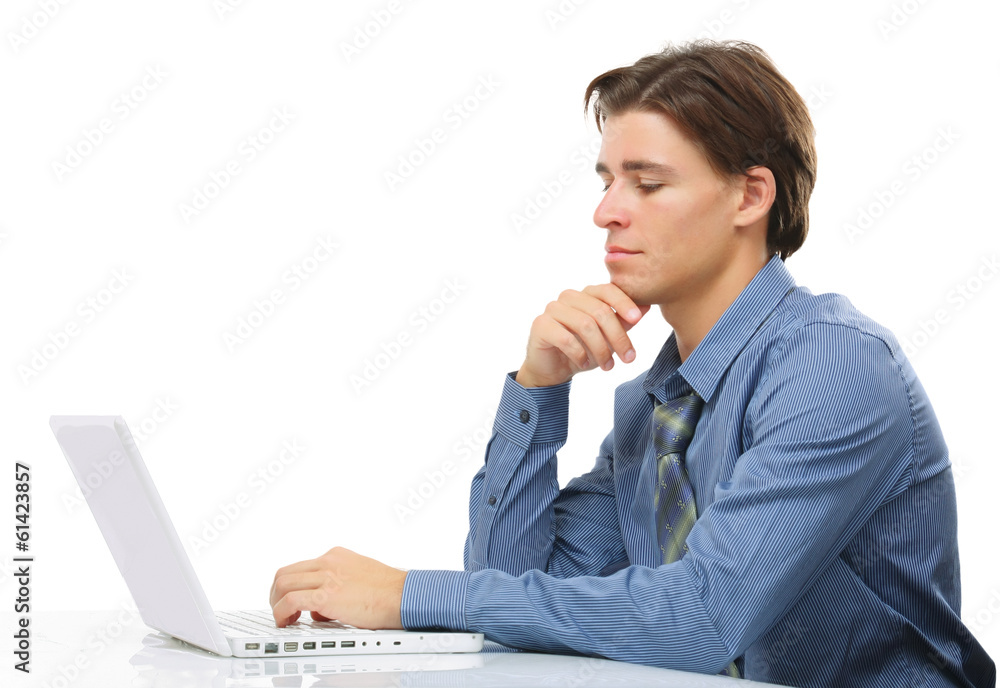 A young man sitting in front of a laptop A young man sitting in front of a laptop