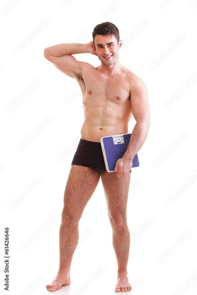 Healthy young man with a weight scale Isolated