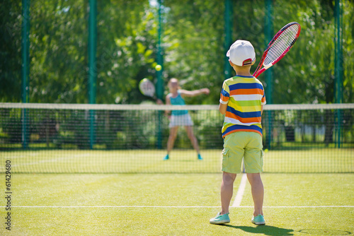 Little boy playing tennis