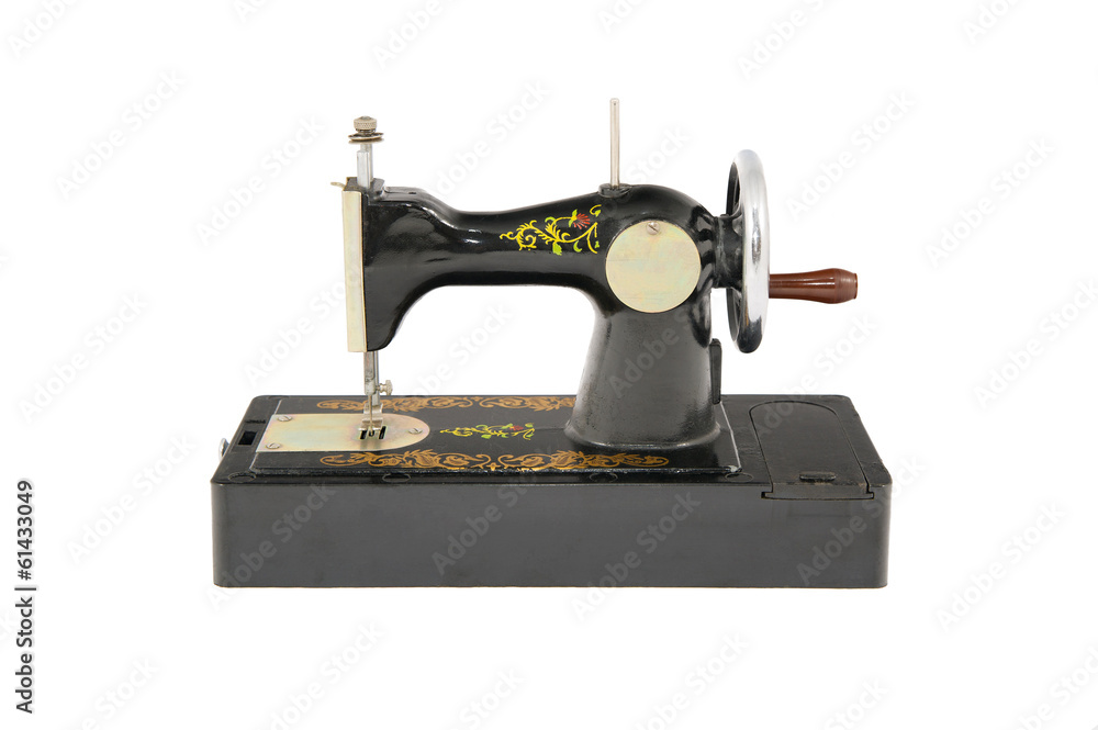 Small old black sewing machine isolated object