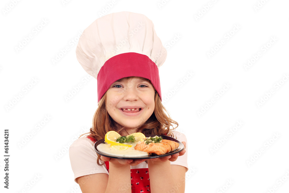 happy little girl cook with salmon fish portion happy little girl cook with salmon fish portion