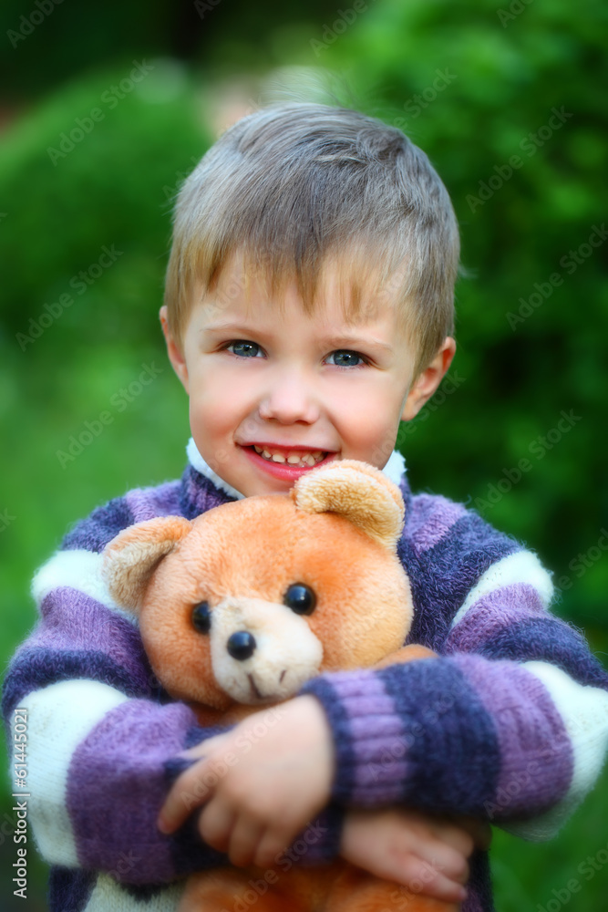 Smiling boy with a soft toy teddy bear Smiling boy with a soft toy teddy bear