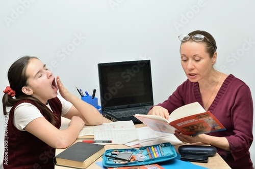 Schoolgirl teen girl listens the teacher and yawns