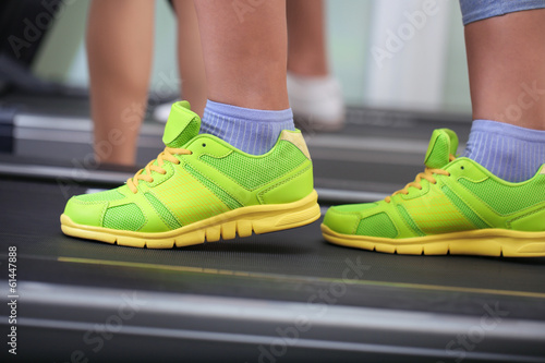 Women legs on treadmill in gum