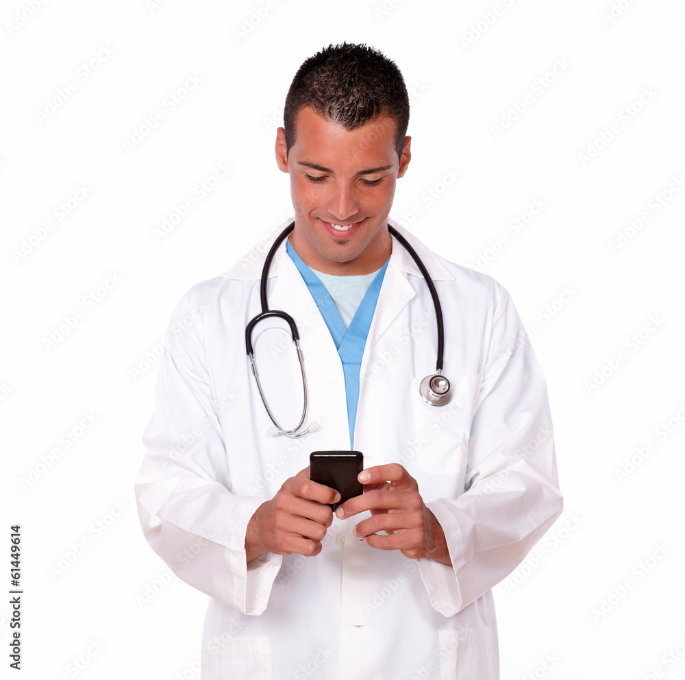 Handsome male doctor texting a message Handsome male doctor texting a message