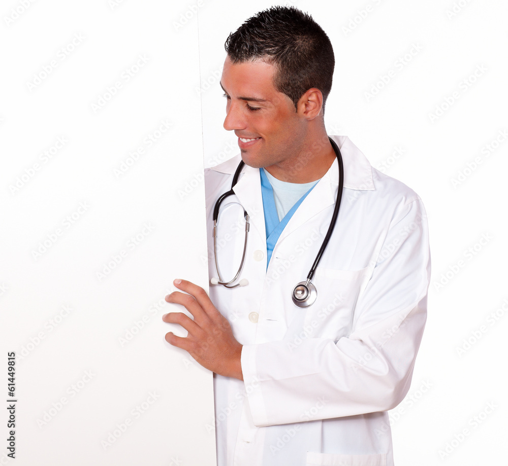 Attractive male doctor holding a white placard Attractive male doctor holding a white placard