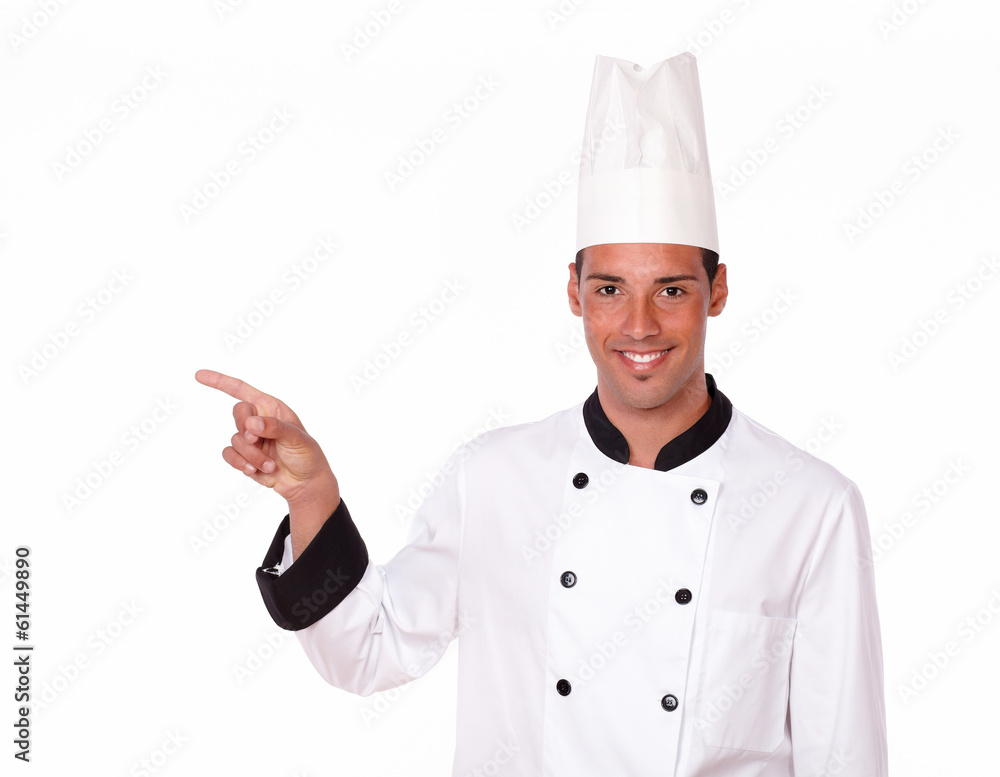 Young male chef pointing to his right Young male chef pointing to his right
